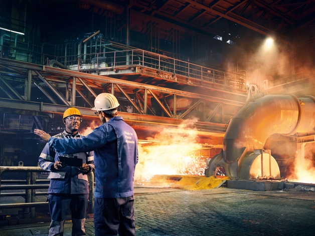To teknikere i samtale på en metalfabrik.